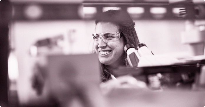 Team member working on a microscope