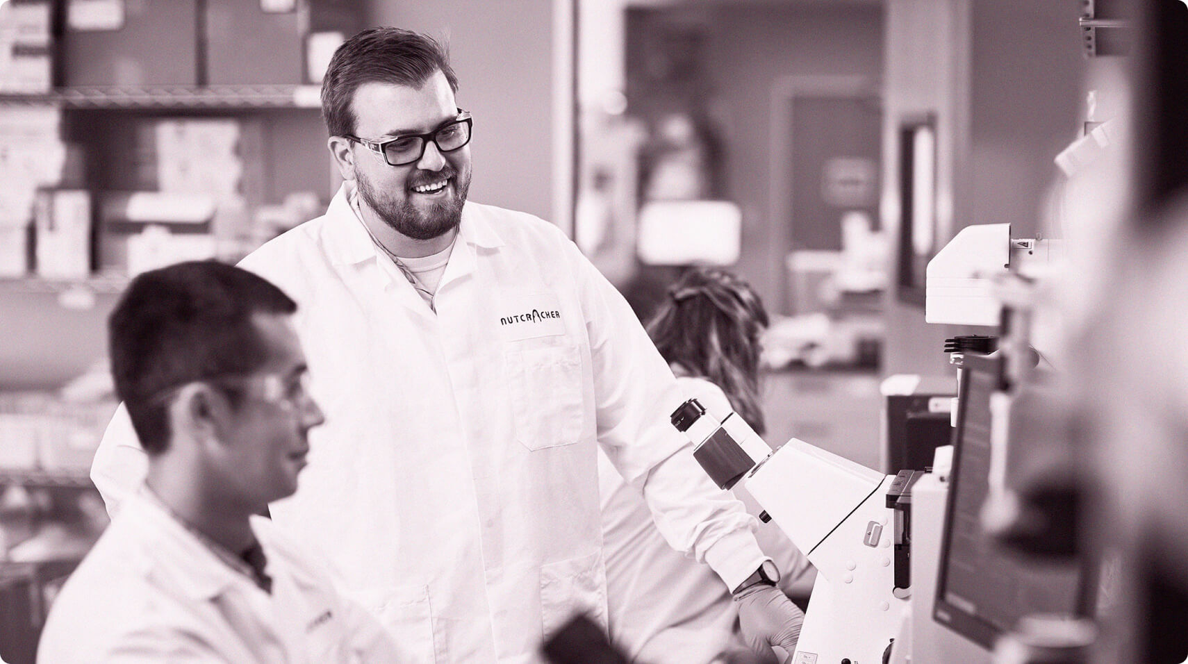 Two team members working near microscopes